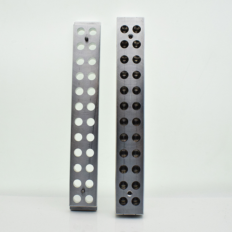 Open 24-hole lipstick mold showing the round flat-top forming positions